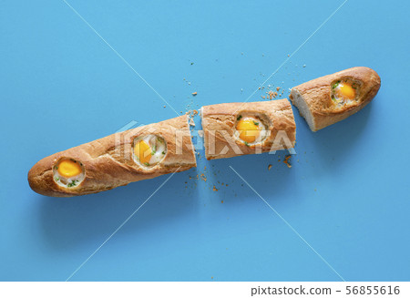 Baked eggs in french bread loaf. Breakfast table 56855616