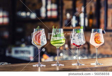 Gin tonic cocktails in wine glasses on bar counter Gin tonic cocktails in wine glasses on bar counter 56856038