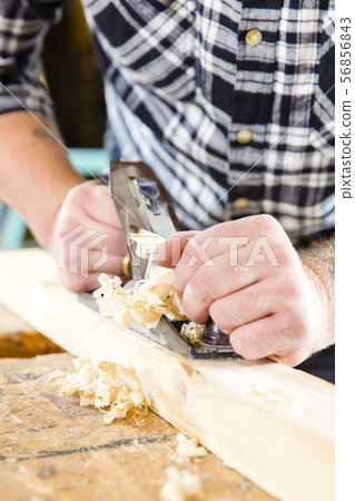 Close-up of carpenter work with plane on wood plank 56856843