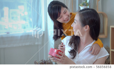 the daughter of a teenager is giving a gift to the the daughter of a teenager is giving a gift to the 56856858