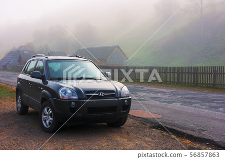 suv on the road side in fog suv on the road side in fog 56857863