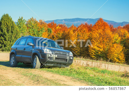 suv on the gravel country road side in mountains suv on the gravel country road side in mountains 56857867