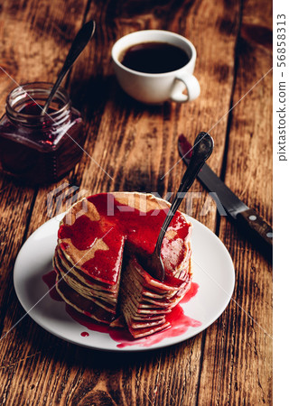 Stack of pancakes with berry jam 56858313