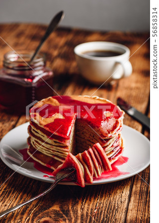 Stack of pancakes with berry jam 56858314