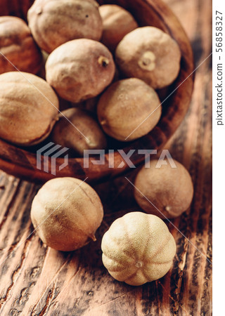 Dried limes on wooden table Dried limes on wooden table 56858327