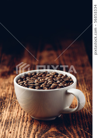 Roasted coffee beans in cup 56858334