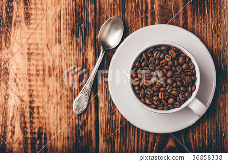 Cup full of roasted coffee beans 56858338