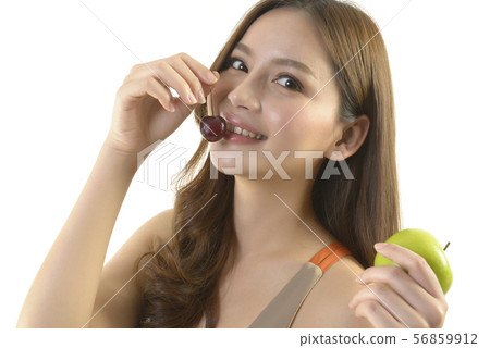 Pretty asian woman with apple and cherry. Pretty asian woman with apple and cherry. 56859912