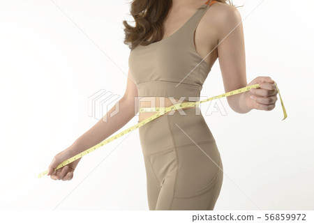 Slim young Asian woman measuring of her body. 56859972