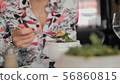 Unrecognized female tourist eats traditional soup with croutons, melted cheese and greens in a Paris 56860815