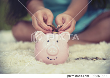 Adorable kids saving coins in piggy bank. Happy Adorable kids saving coins in piggy bank. Happy 56861365