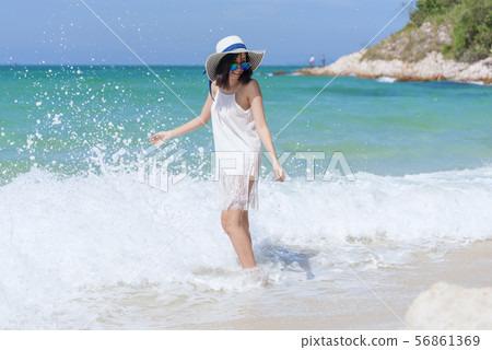 Summer time woman vacation on the beach. Cheerful Summer time woman vacation on the beach. Cheerful 56861369