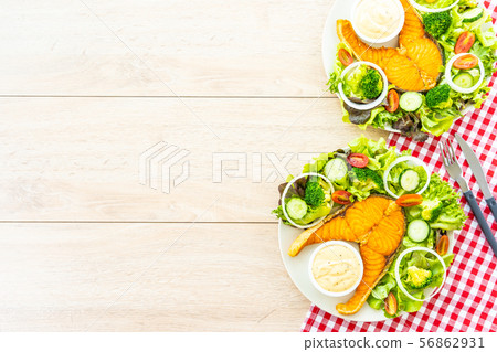 Grilled salmon meat steak with fresh vegetable 56862931