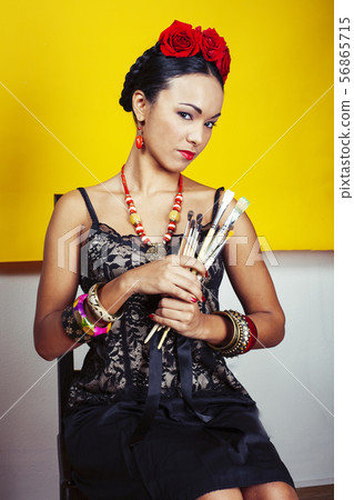 young pretty mexican woman smiling happy on yellow background, lifestyle people concept 56865715