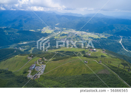 View of Hakuba village and Happo-one ski resort from the perspective of Kuroishihira (aerial photography by drone) 56866565