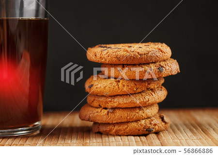 A pile of oatmeal cookies with chocolate chips and A pile of oatmeal cookies with chocolate chips and 56866886