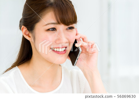A young woman using a smartphone A young woman using a smartphone 56869630