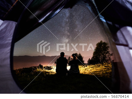 Couple tourists resting at night camping under stars 56870414