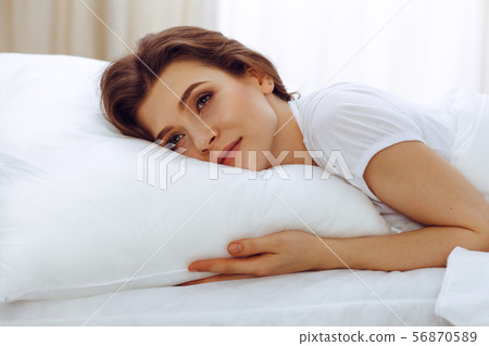 Beautiful young woman sleeping while lying in her bed. Concept of pleasant and rest reinstatement 56870589