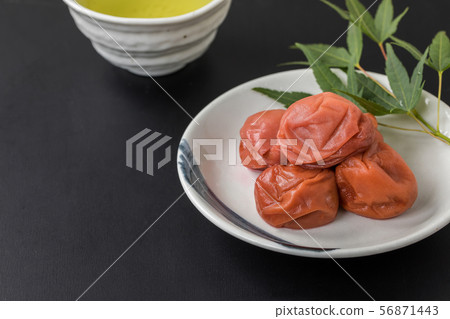 Umeboshi and Japanese tea luxury copy space on black background 56871443