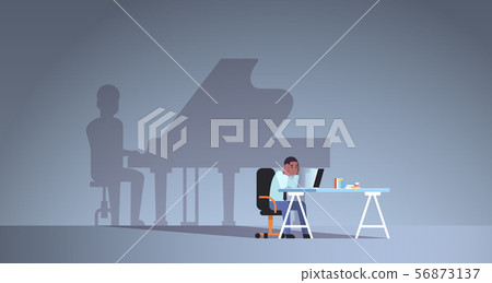african american man sitting at workplace using laptop shadow of man playing piano imagination 56873137