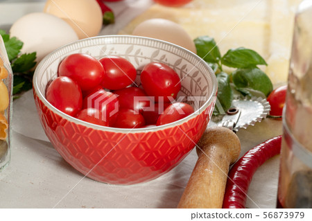 cherry tomatoes in a small red bowl 56873979