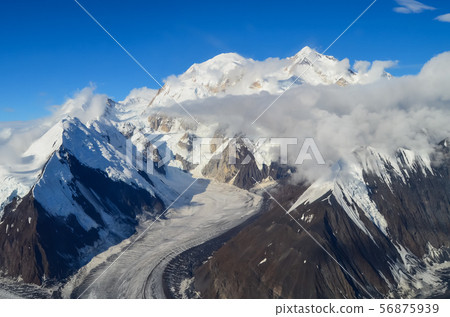 Aerial view of Mount Denali - mt Mckinley peak from a plane with glaciers around and blue sky above 56875939