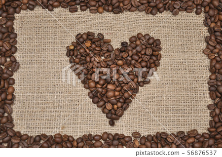 Coffee beans in heart shape. On rag cloth background Coffee beans in heart shape. On rag cloth background 56876537