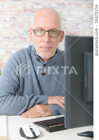 Senior businessman working on computer Senior businessman working on computer 56878154