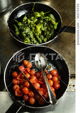 cooked cherry tomatoes and green peppers cooked cherry tomatoes and green peppers 56878350