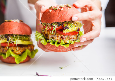Cooking pink vegan burgers with beans cutlet Cooking pink vegan burgers with beans cutlet 56879535