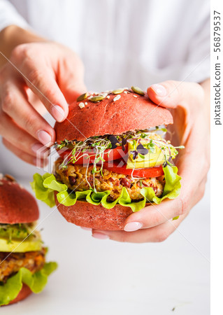 Cooking pink vegan burgers with beans cutlet Cooking pink vegan burgers with beans cutlet 56879537