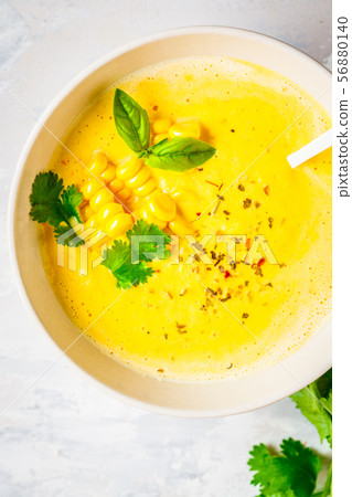 Vegan corn cream soup in white bowl Vegan corn cream soup in white bowl 56880140