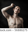 Man Shaves His Head 56880275