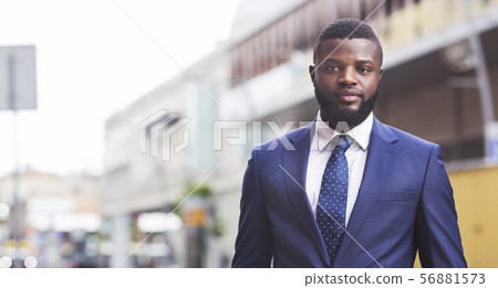 Serious millennial employee posing to camera against cityscape 56881573