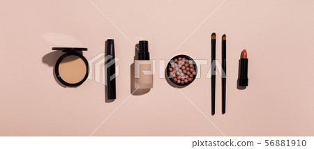 Makeup products in row on pink background 56881910