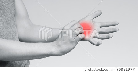Young man scratching itch on his hand Young man scratching itch on his hand 56881977