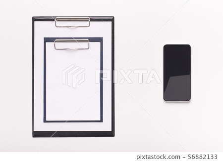 Two different sized clipboards and cellphone with blank screen Two different sized clipboards and cellphone with blank screen 56882133