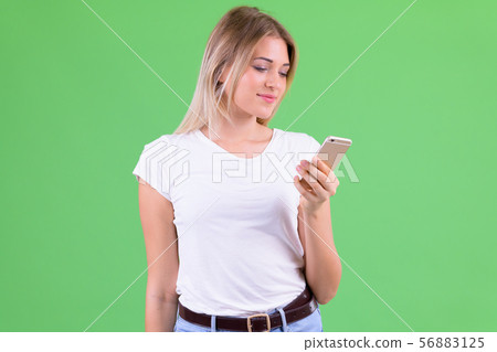 Portrait of young beautiful blonde woman using phone 56883125