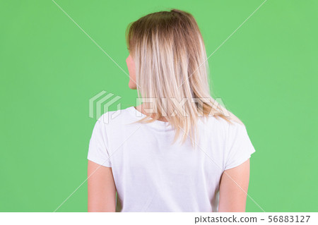 Rear view of young blonde woman looking over shoulder 56883127