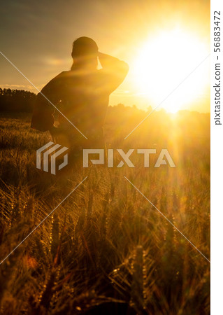 African woman in traditional clothes Sunset Field 56883472