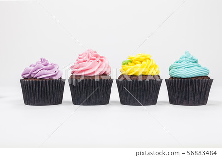 Four Chocolate Cupcakes With Colorful Icing or 56883484