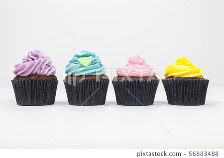 Four Chocolate Cupcakes With Colorful Icing 56883488