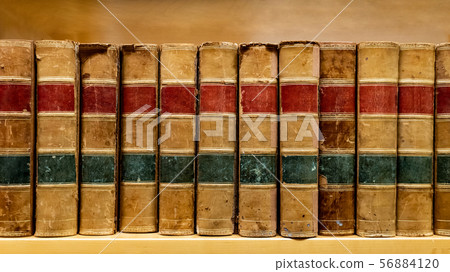 Antique books on wooden bookshelf in library Antique books on wooden bookshelf in library 56884120