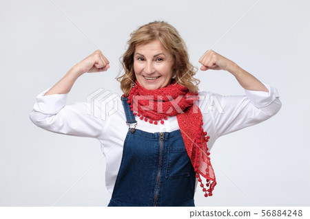 Mature caucasian woman showing biceps, feeling strong Mature caucasian woman showing biceps, feeling strong 56884248