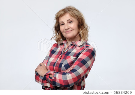woman smiling and looking at camera with confidence. 56884269