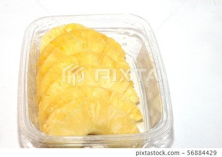 pineapple in a pan cut into slices 56884429