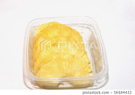 pineapple in a pan cut into slices 56884432