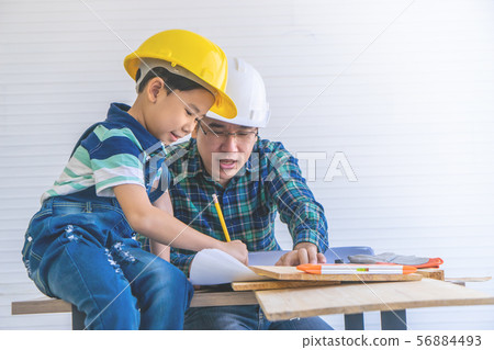Builder Father is teaching his son to read the Builder Father is teaching his son to read the 56884493