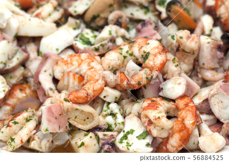 rich and mixed seafood salad on a serving plate 56884525